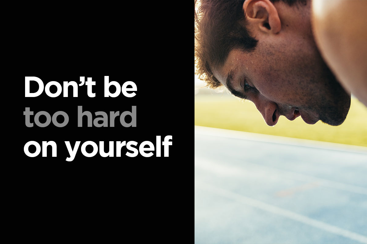 Picture divided on half. On the left half, there is a writting: Don't be too hard on yourself'', white letters on a black background. ON the left, there is a face of a man, he is sweaty and obviously bent over after running or difficult exercise.