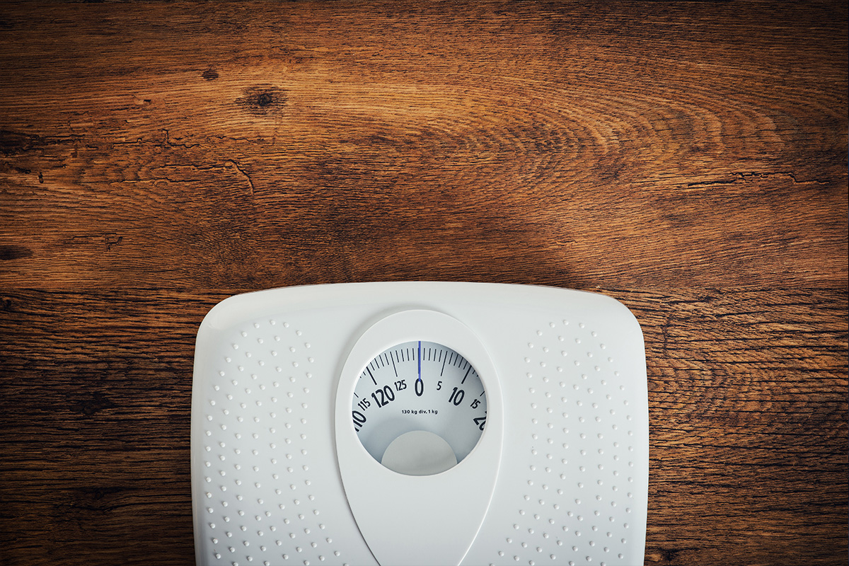 weight scale on a wooden floor, showing zero