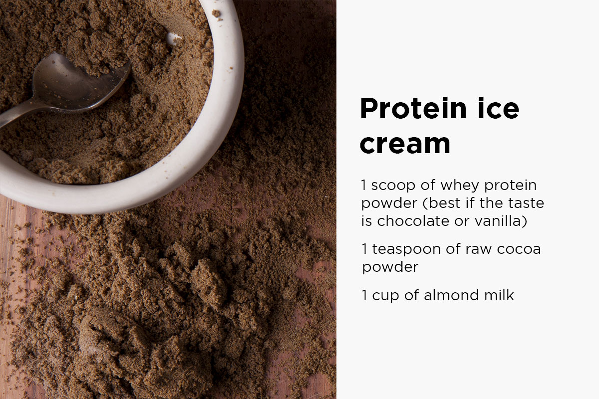 Ceramic bowl filled with chocholate protein powder, spoon inside the bowl, some powder sprinkled over the wooden backgroun upon which the bowl is placed. Following text written on the right side of the picture: ''Protein ice cream: 1 scoop of whey protein (best if the taste is chocholate or vanilla), 1 teaspoon of raw cacao powder, 1 cup of almond milk''.